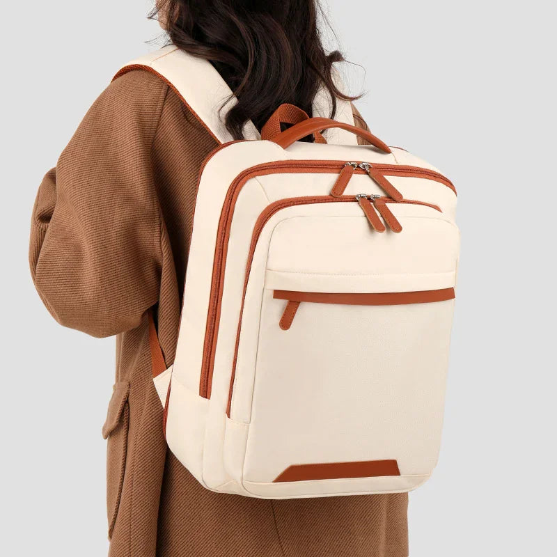 Person wearing a beige expandable computer backpack