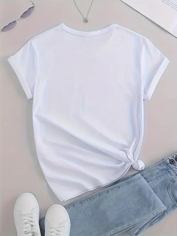 White short sleeve t-shirt on a table with jeans and sneakers