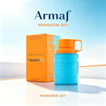 Blue and orange perfume bottle with its orange box against a clear blue sky background