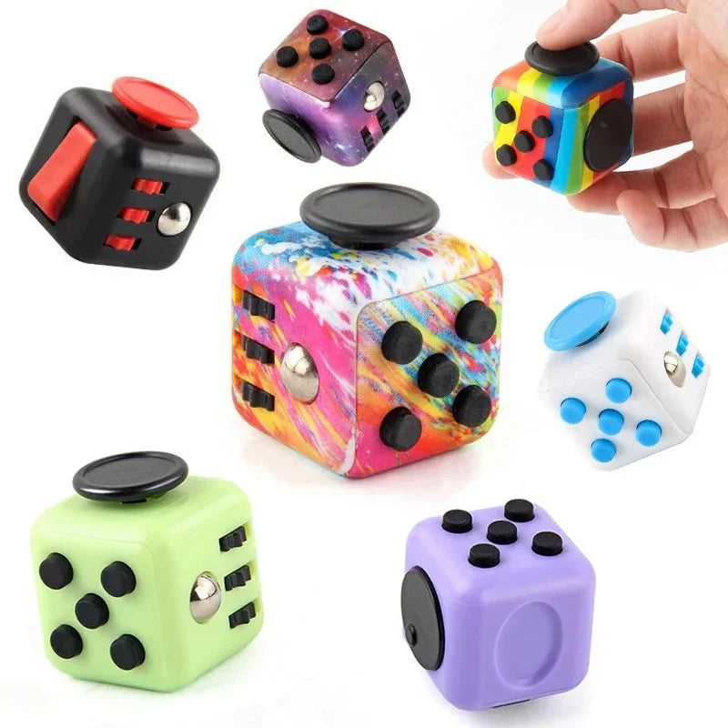 Assorted sensory fidget cubes showing different designs and a hand holding one