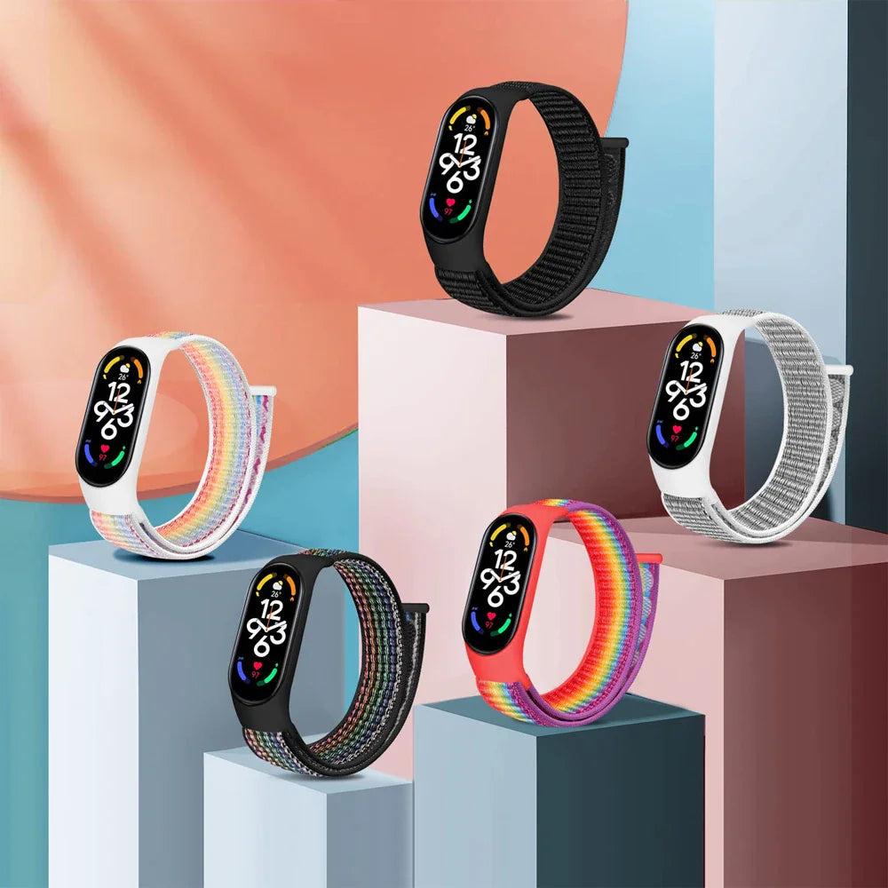 Set of five different fitness tracker bands displayed on colored geometric pedestals