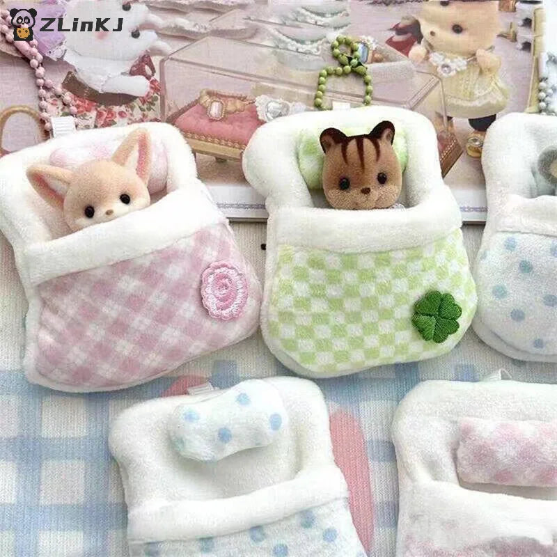 Small plush sleeping bags with pillows and flower appliques for miniature toy figurines