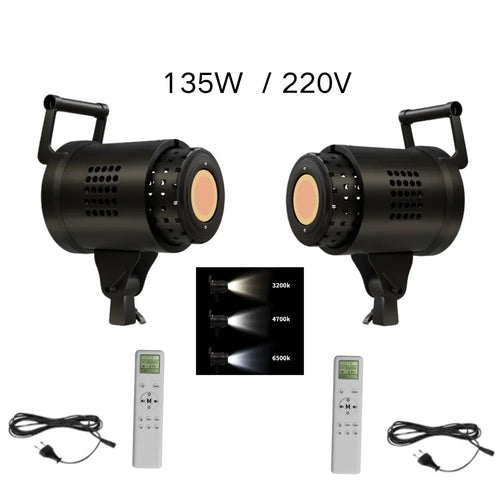 Two studio photography LED lights with power cables and remote controls showing different color temperature modes