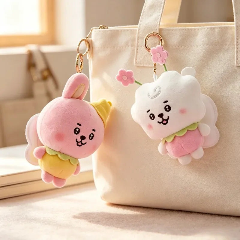 Plush rabbit and sheep character keychains hanging from a beige canvas bag