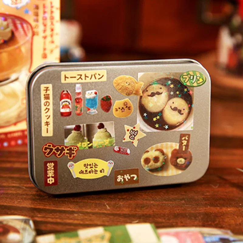 A small decorative metal tin decorated with various small food-themed stickers