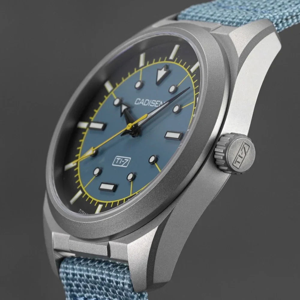 Side profile of a blue-dial titanium automatic watch with a blue canvas strap