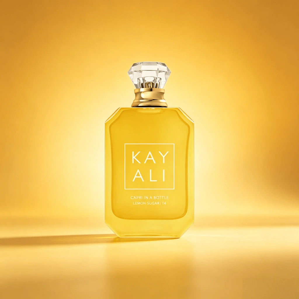 Bottle of lemon sugar scented perfume on a golden yellow background