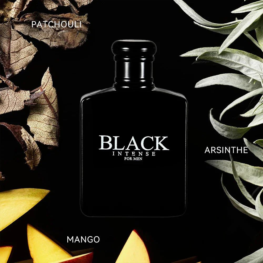 Black perfume bottle for men surrounded by patchouli leaves, mango slices, and absinthe