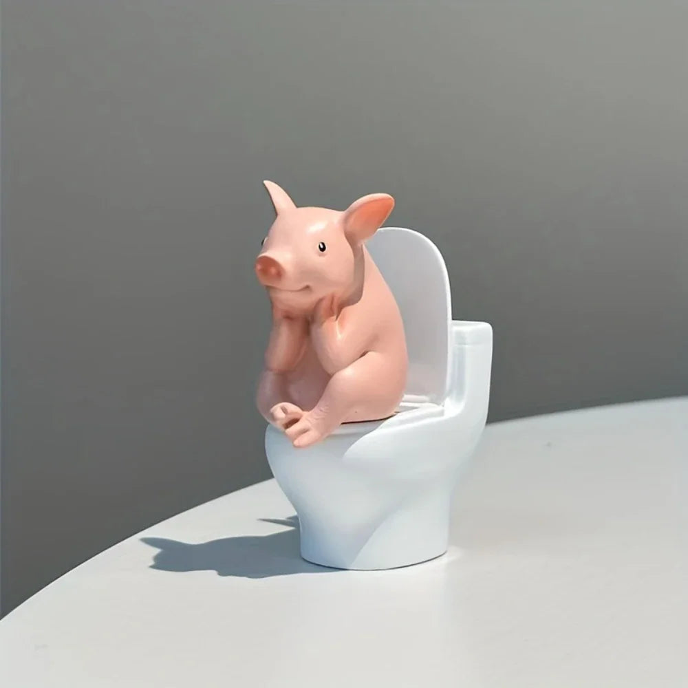 A side-angle view of a cute pink pig figurine sitting on a miniature white toilet.