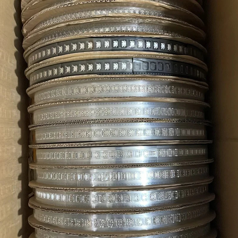A cardboard box containing multiple reels of electronic components or connector parts.