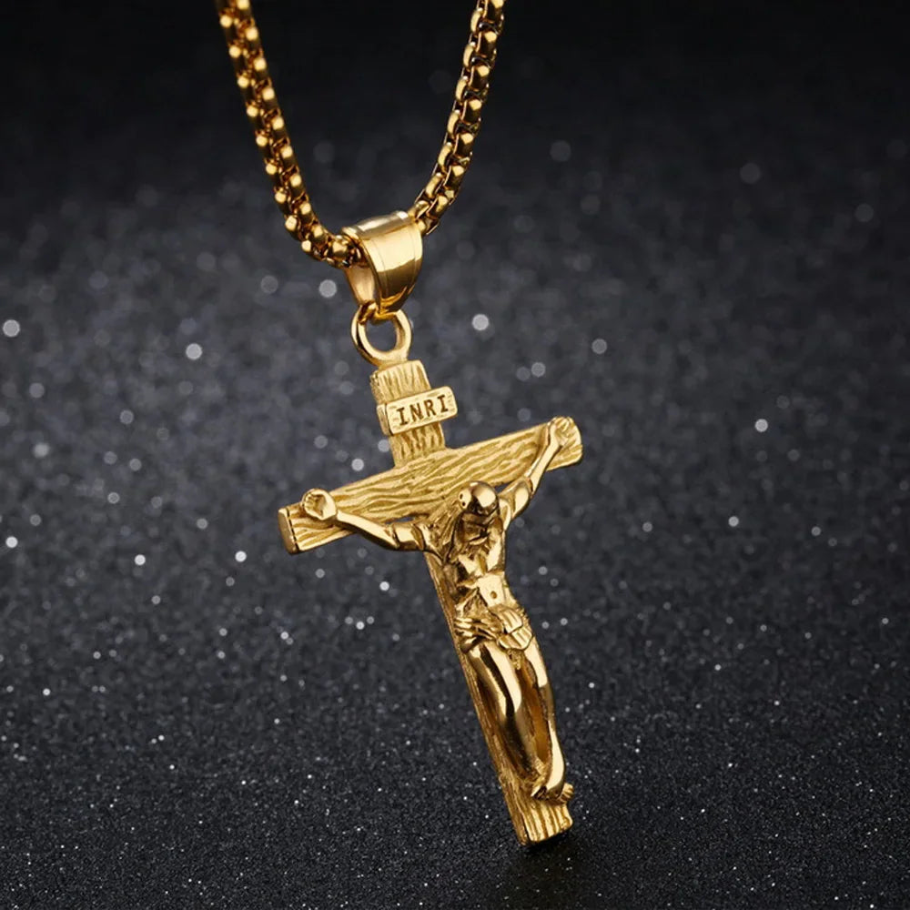 Gold crucifix pendant necklace on a black textured background