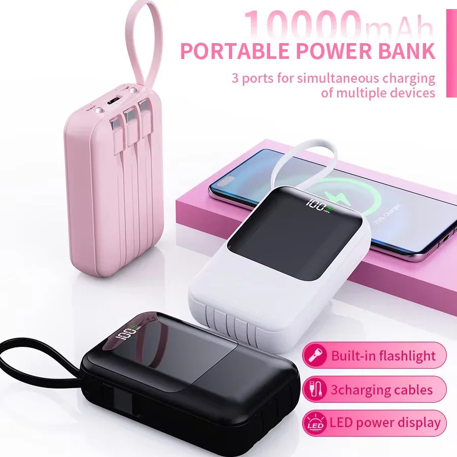 Three portable power banks in different colors charging a smartphone on a pink base.