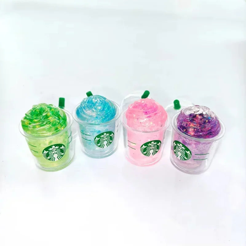 Collection of four glittery, iced coffee cup shaped squishy fidget toys in green, blue, pink, and purple.