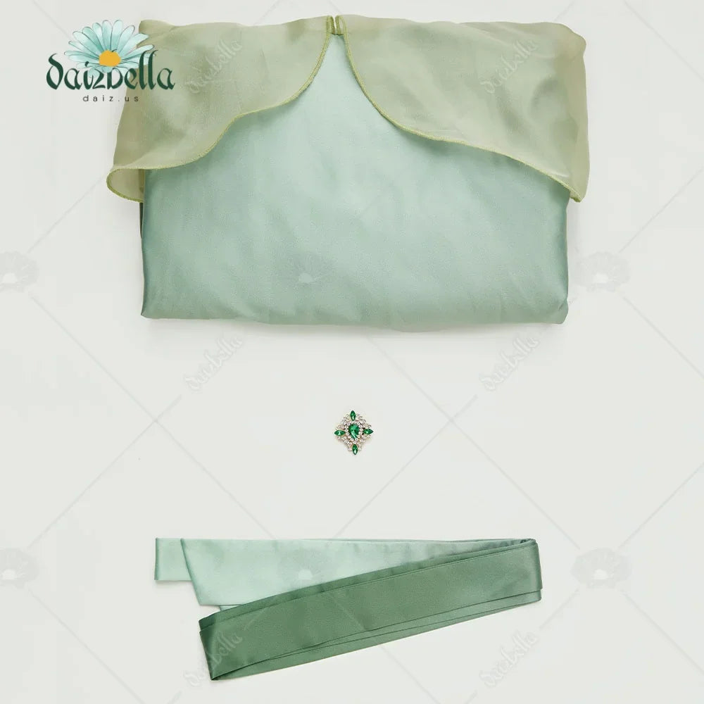 Folded green and yellow gradient fabric, ribbon belt and gemstone brooch accessory set.