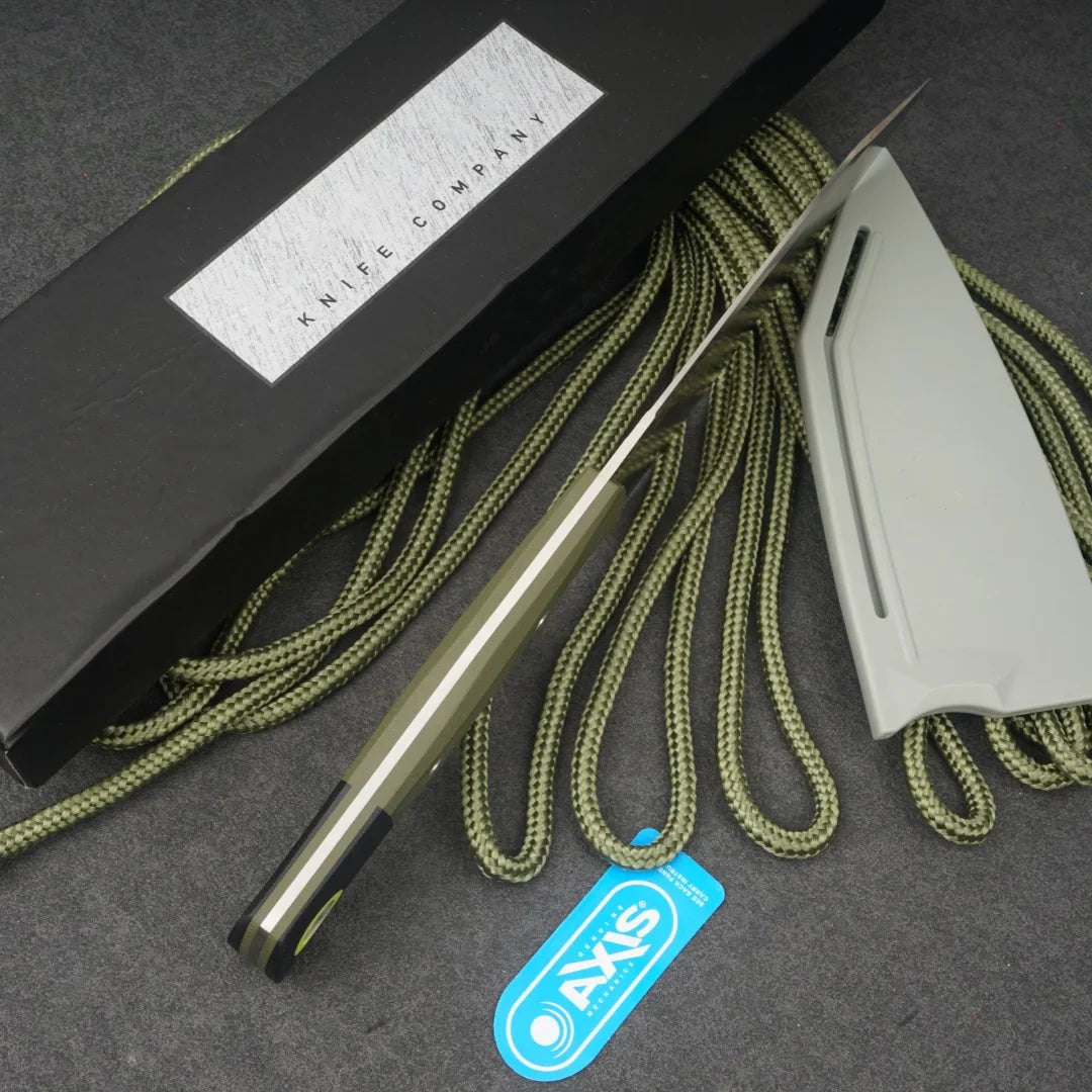 Side profile view of a fixed blade chef knife with a stainless steel blade and olive green and black micarta handle.