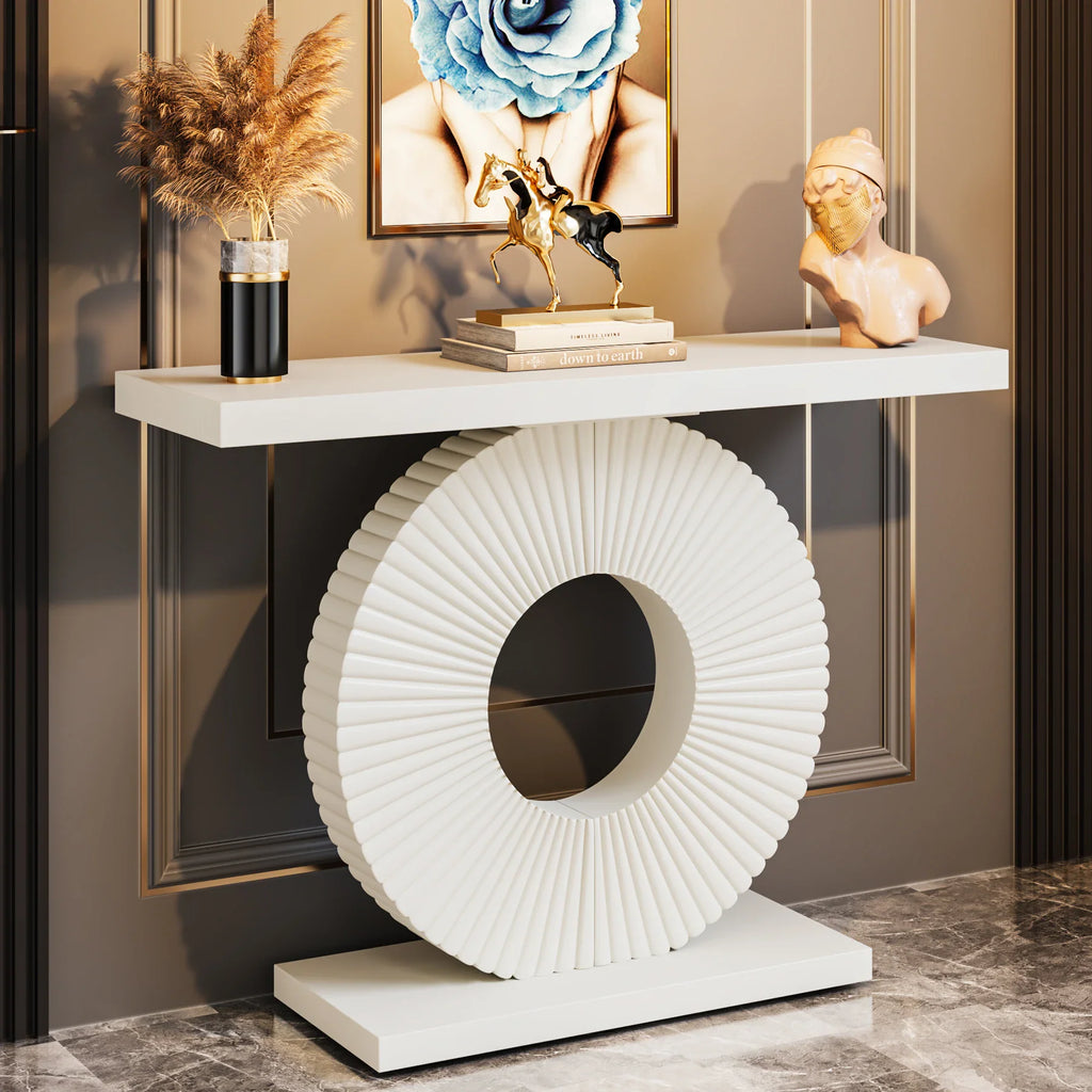 Modern white console table with a circular fluted base in a decorative room setting