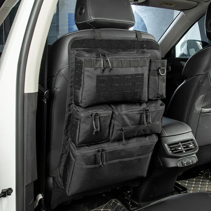 Black tactical car seat back organizer with multiple pockets and storage compartments