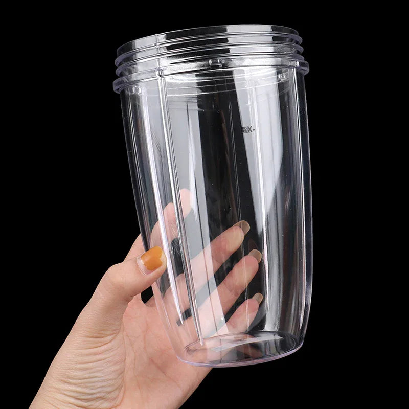 Hand holding a clear plastic replacement blender cup.