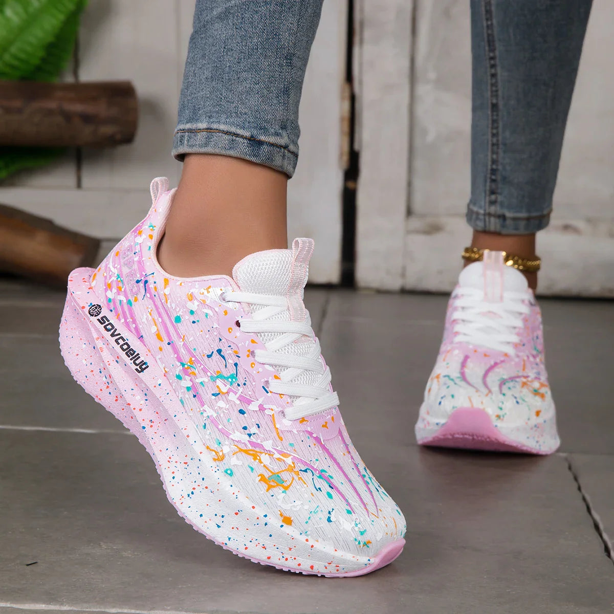 Pink and white paint splatter sneakers with a thick sole
