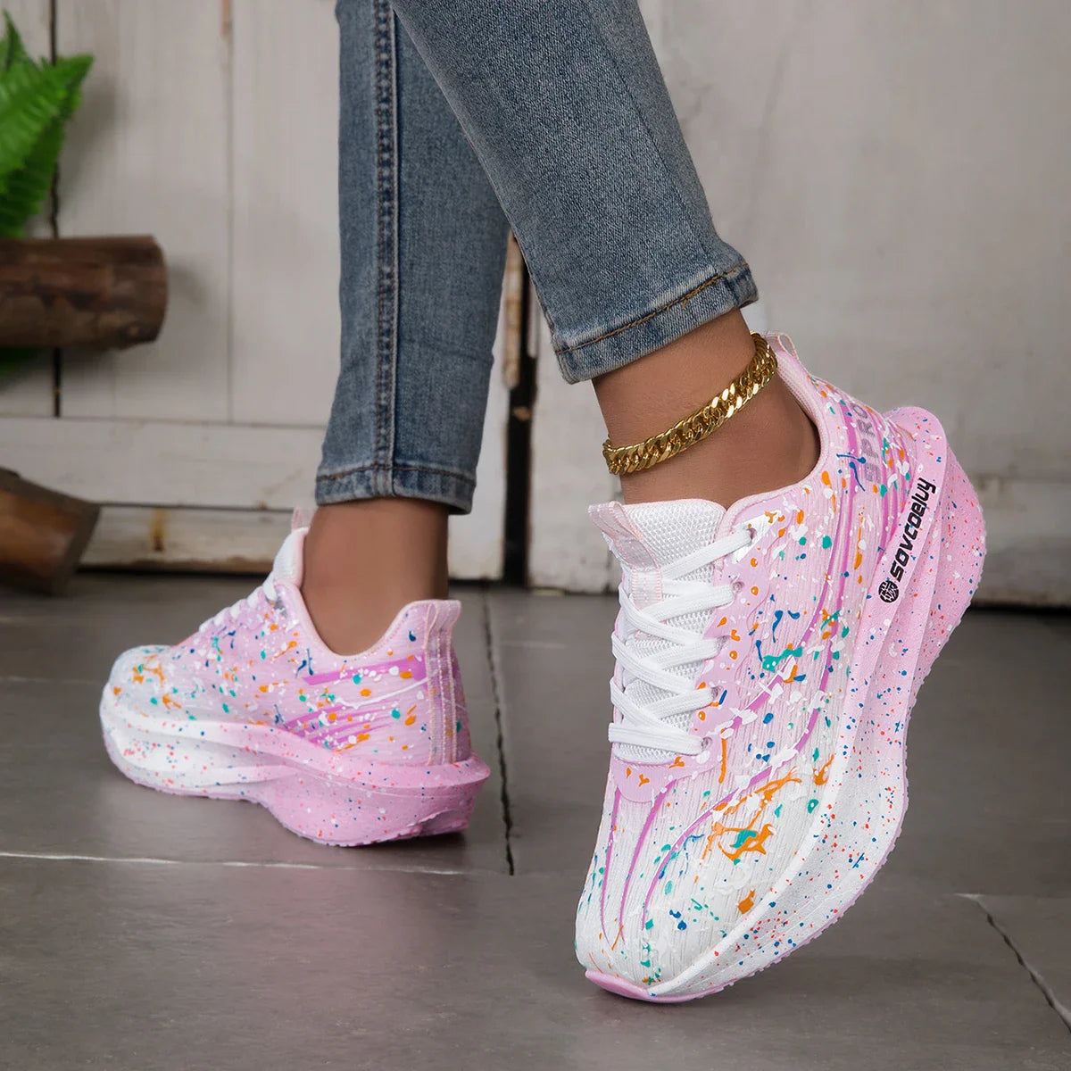 Pink and white paint splatter sneakers with a thick sole