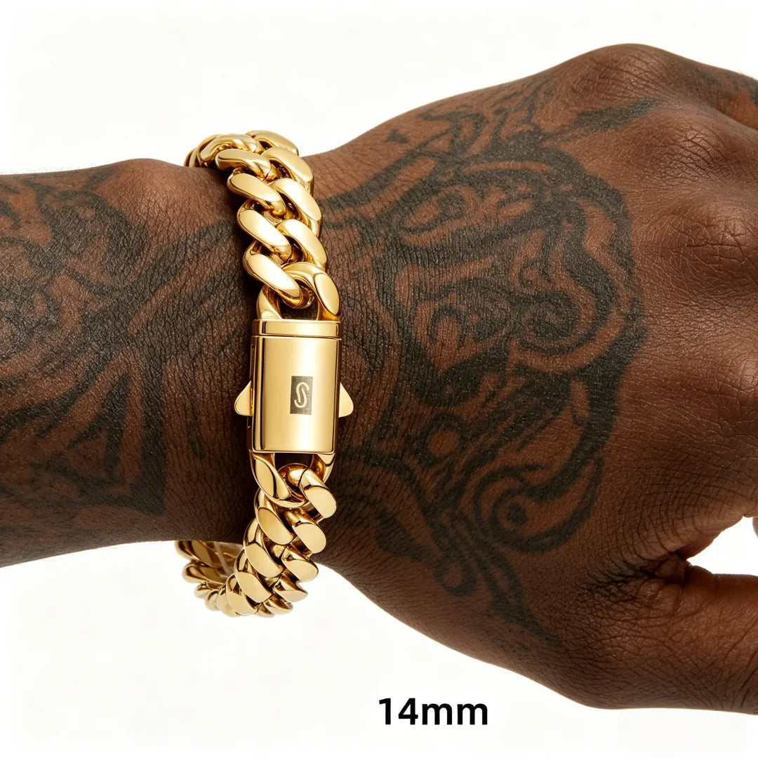 Close-up of a 14mm gold cuban link bracelet on a tattooed arm