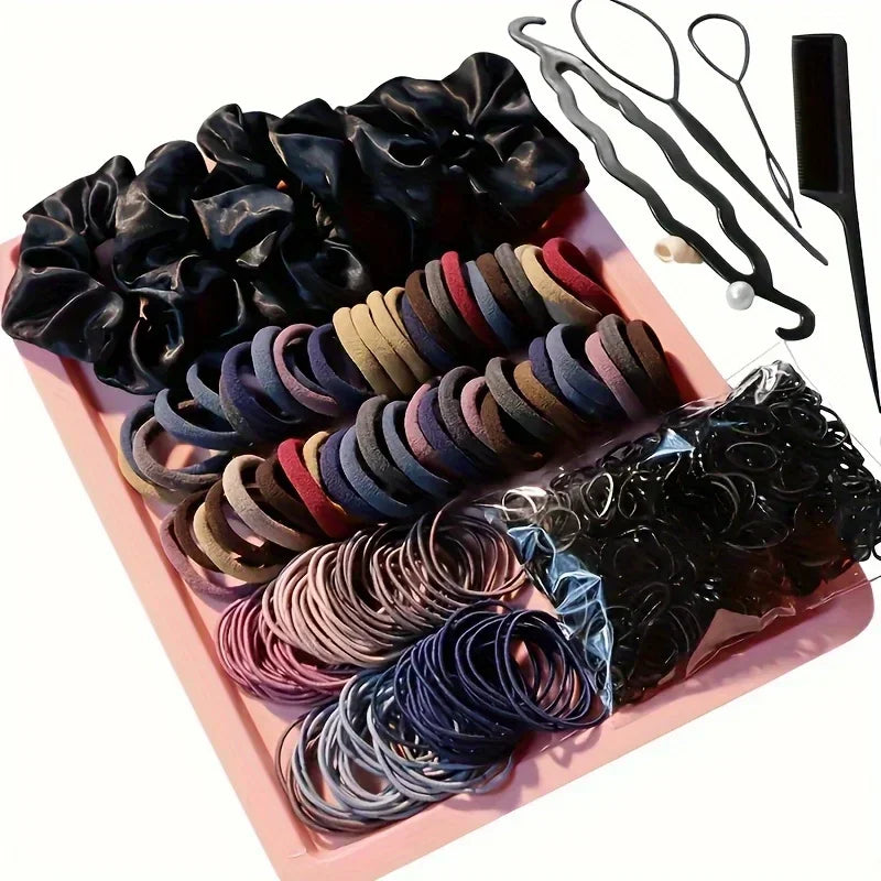 Complete set of hair accessories including fabric scrunchies, elastic bands, and styling tools on a pink tray.