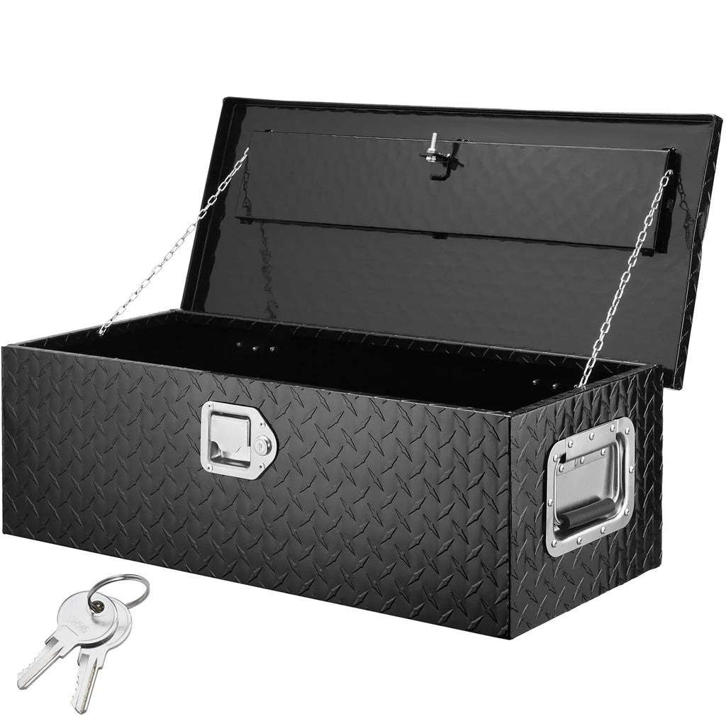 Black diamond plate aluminum truck tool box with lid open, side handles, and a set of keys