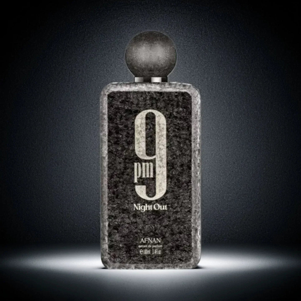 A black textured men's perfume bottle with a round cap against a dark background.