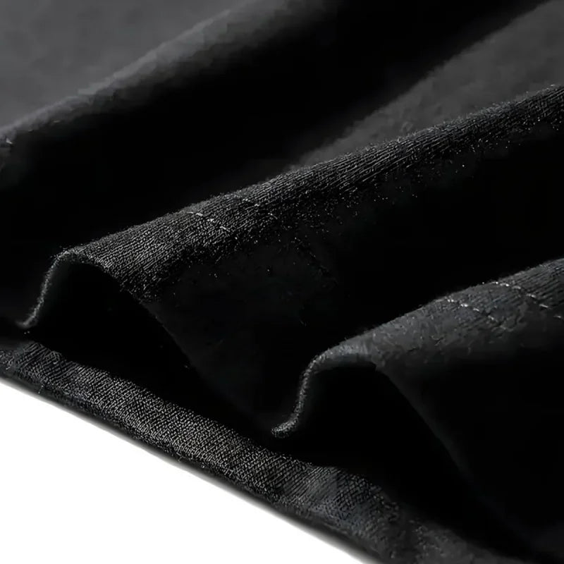 Close-up of the fabric texture of a black t-shirt.