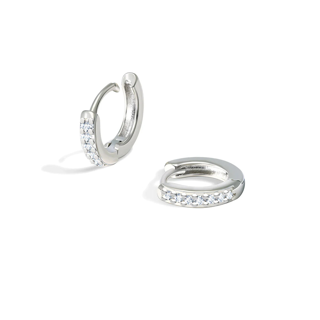 Two small silver hoop earrings with clear crystals.
