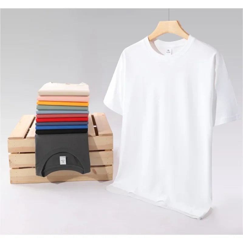 Assorted colors of folded cotton t-shirts stacked on a wooden crate