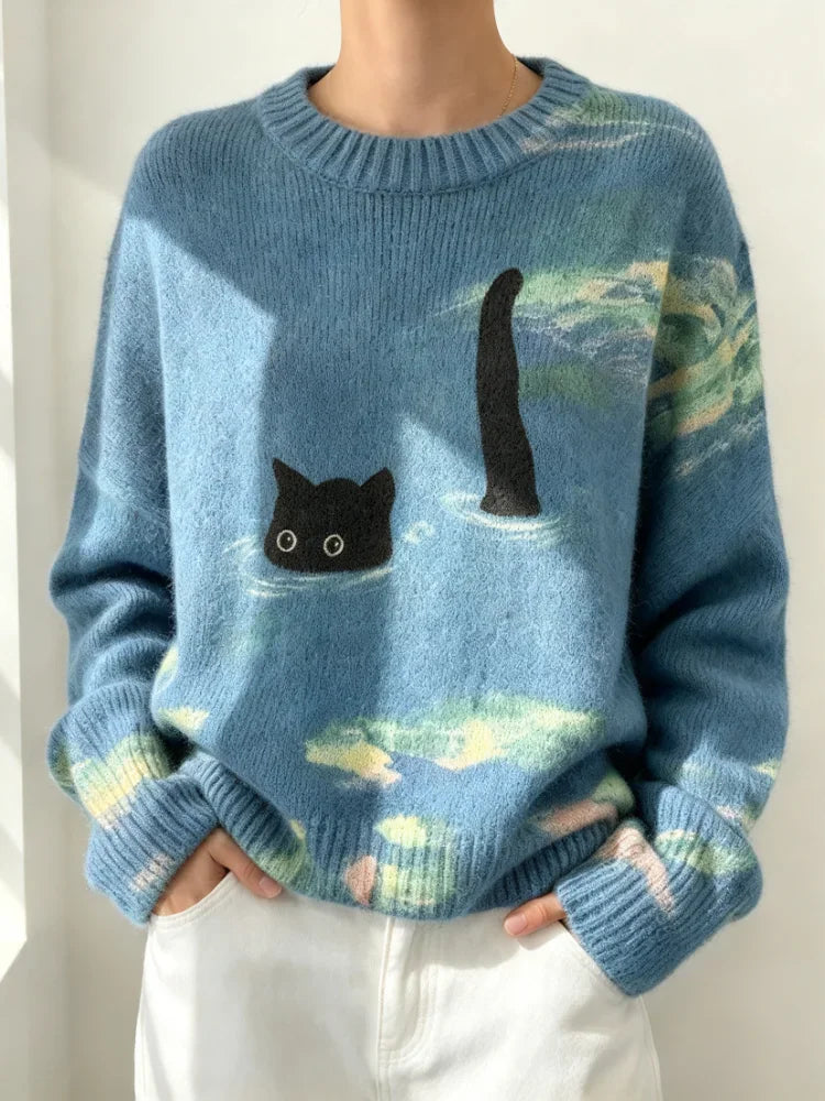 Women's light blue crew neck loose knit sweater with a black cat swimming in the ocean graphic print