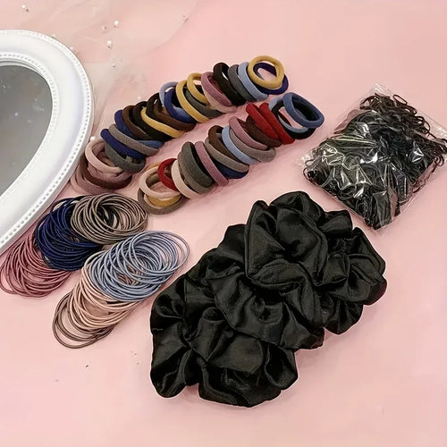 Hair accessory set featuring elastic ponytail holders, fabric scrunchies, and a small plastic hair tool.