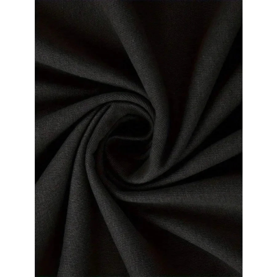 Close-up of the soft fabric texture of a black t-shirt.