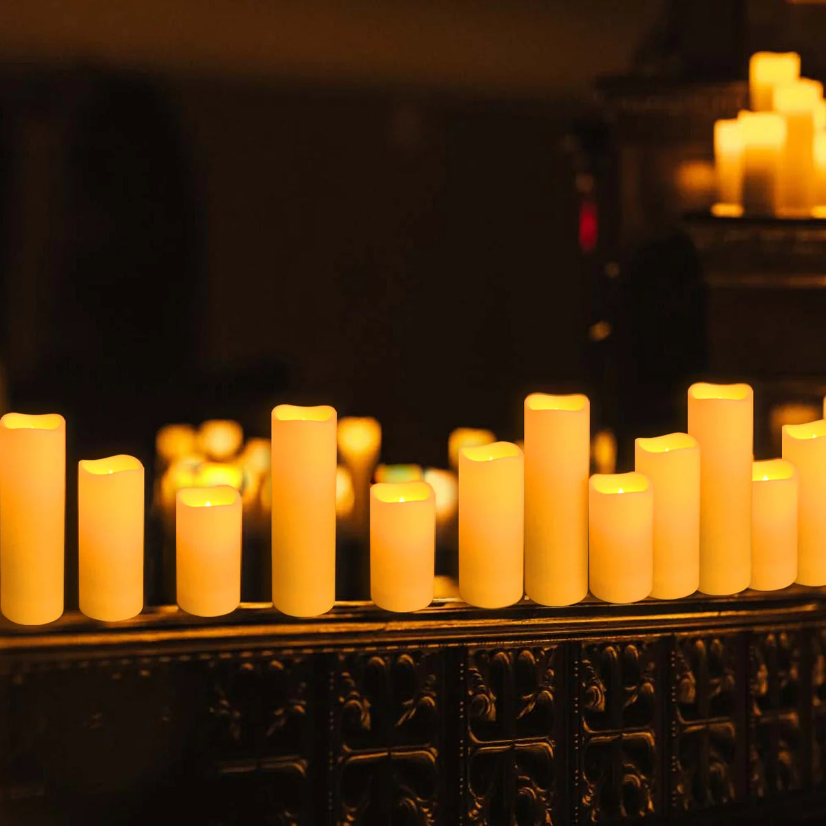 Row of warm white flameless LED pillar candles with a soft glow.