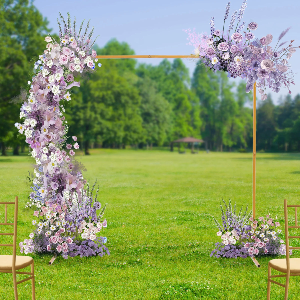 Golden metal square wedding arch stand decorated with purple flowers in an outdoor garden setting