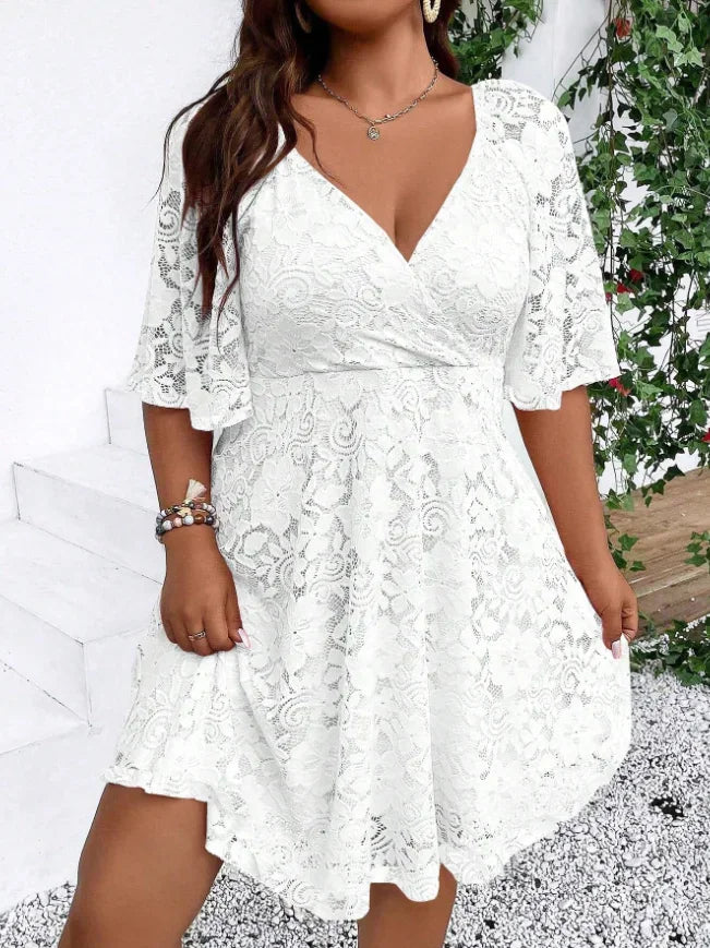 Front view of a white lace mini dress with short flutter sleeves and a V-neckline