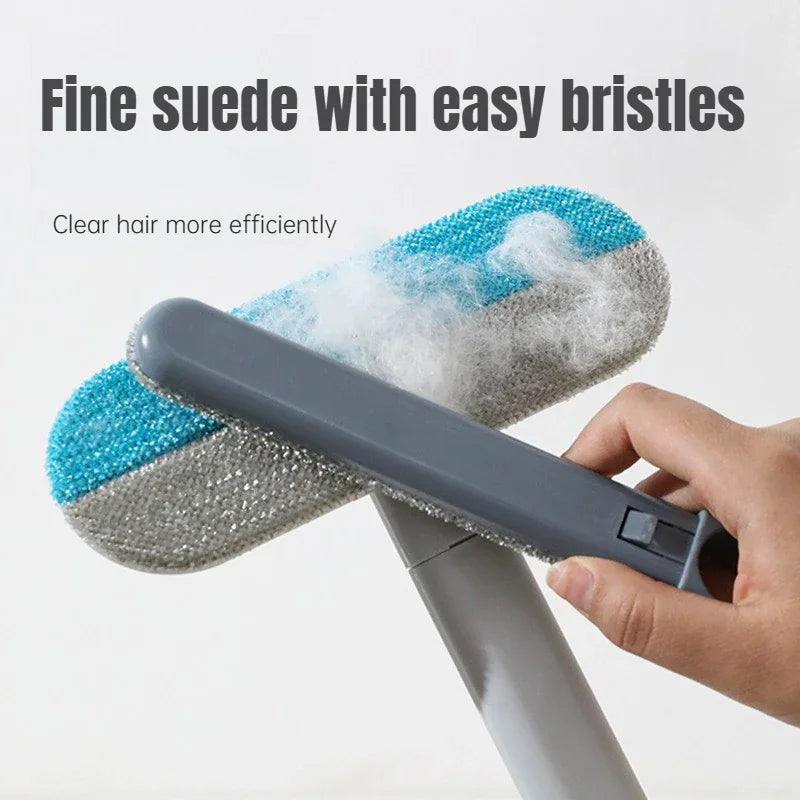 Close-up of a long-handle pet hair removal brush showing the texture and cleaning action