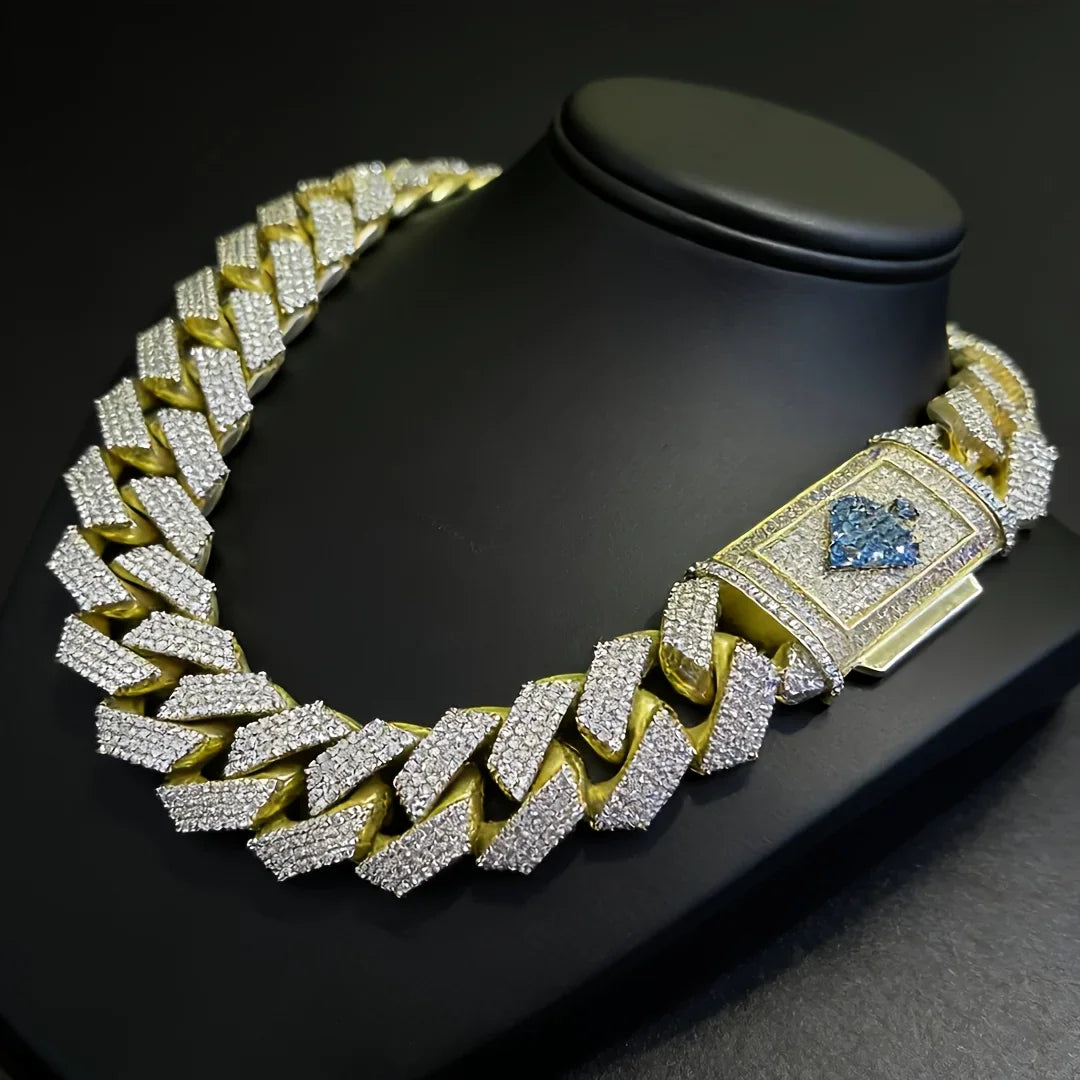 Gold cuban link necklace with diamond-like stones and spade emblem on clasp on black display stand