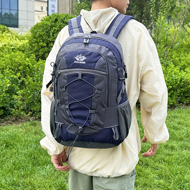 Person wearing a blue and grey hiking backpack