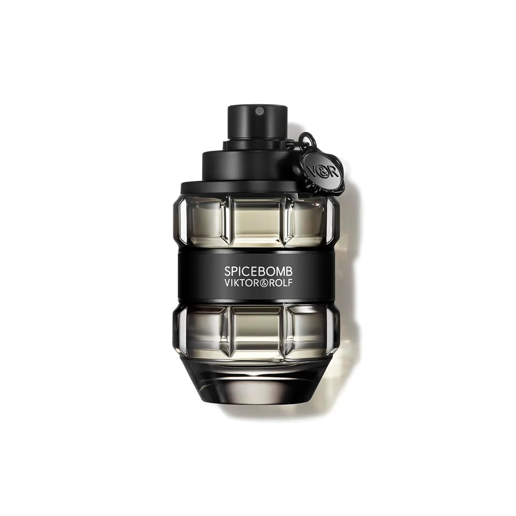 A glass perfume bottle shaped like a grenade, in a transparent black finish with a black band, against a plain white