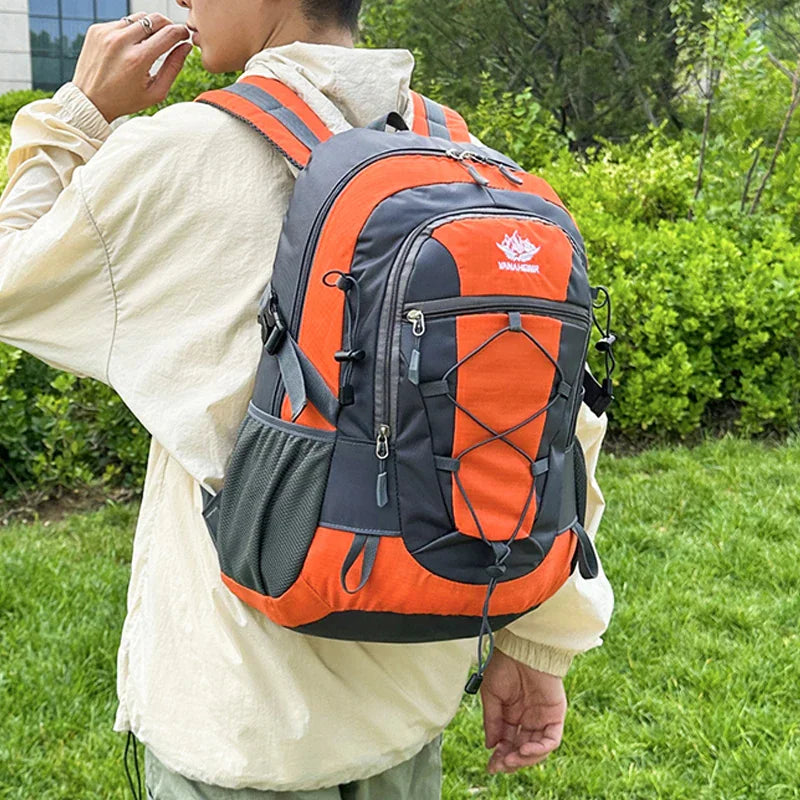 Person wearing an orange and grey hiking backpack