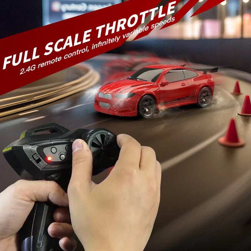 Person holding a remote controller for a 1/64 scale RC drift car on a miniature track
