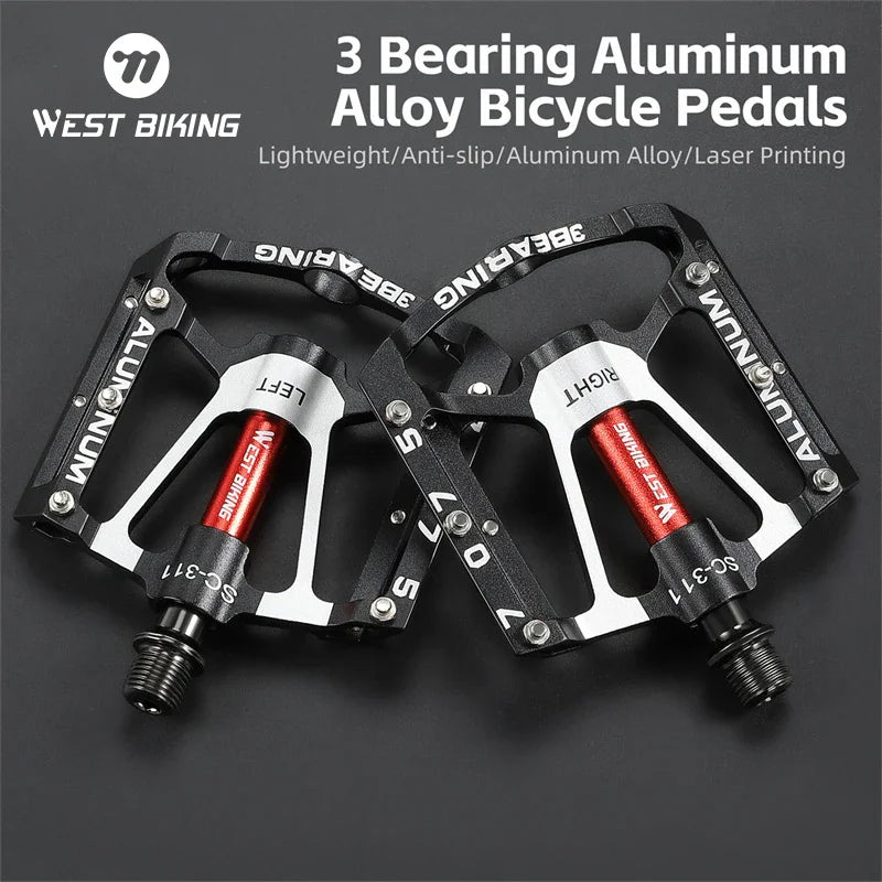 Pair of black and silver aluminum bicycle pedals with red center axles