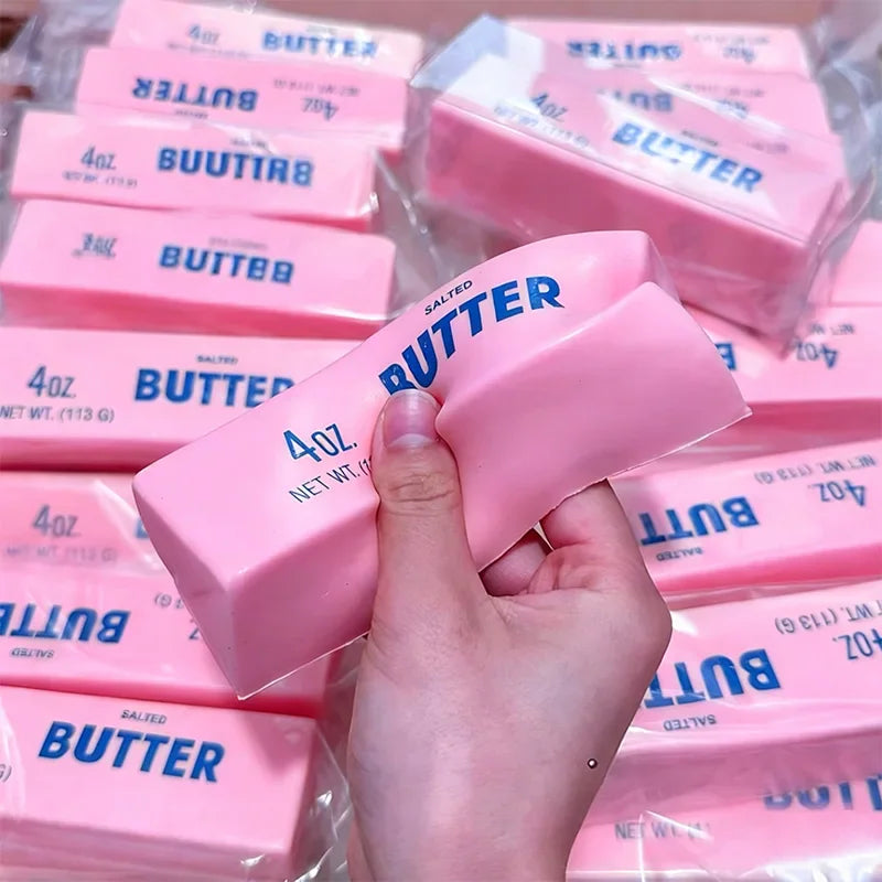 Hand holding a squishy pink butter stick toy
