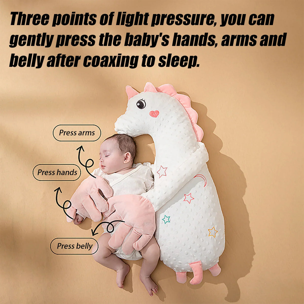 A baby sleeping with a unicorn shaped pillow with labels showing how to press on it.
