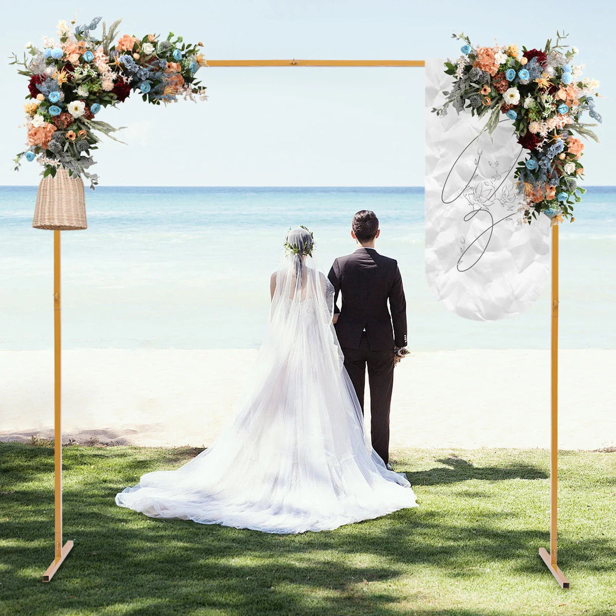 Golden metal square wedding arch stand with floral decorations with a bride and groom standing before it