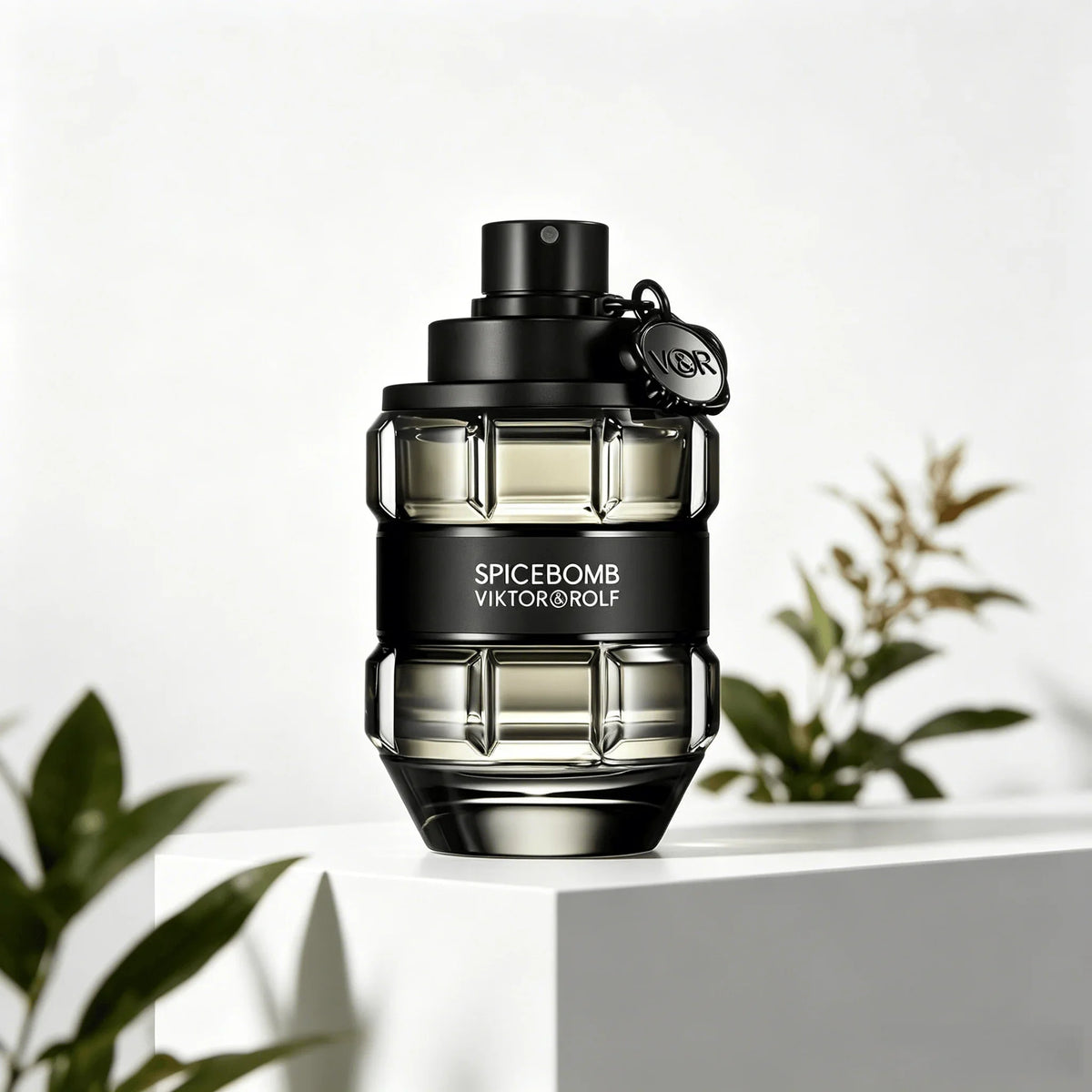 A glass perfume bottle shaped like a grenade, in a transparent black finish with a black band, on a white pedestal with