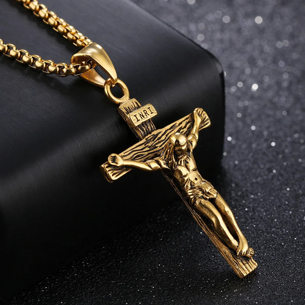 Close-up of a gold crucifix pendant with textured wood-look cross and INRI detail