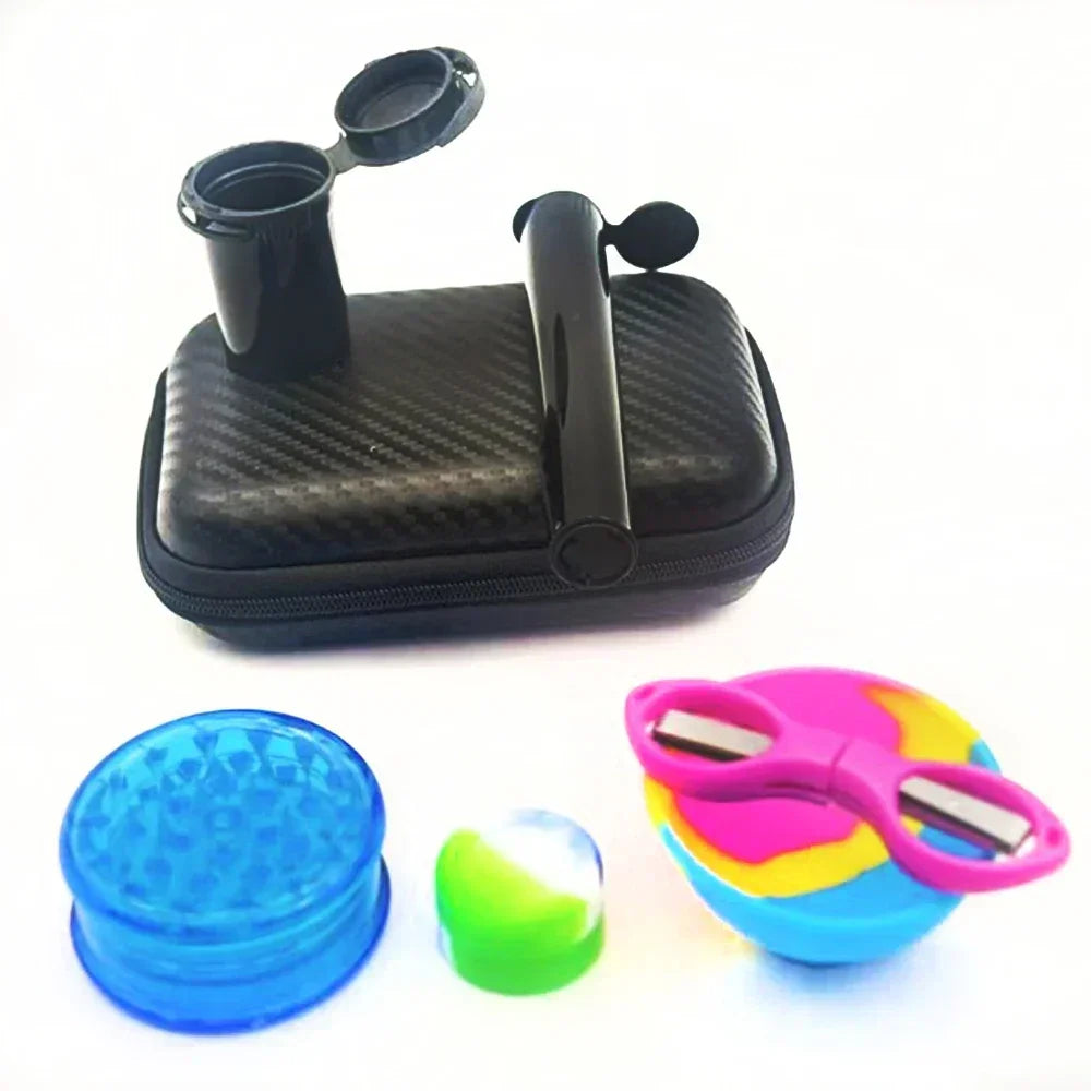 A black carrying case with a tube container, blue grinder, pink scissors, and a small silicone jar arranged outside of it.